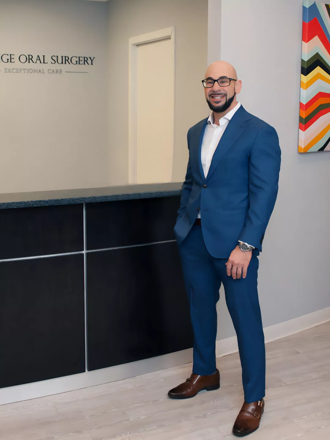 Dr Erakat standing in the lobby - Prestige Oral Surgery.