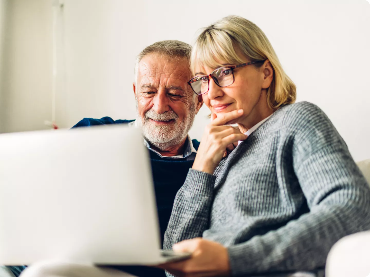 Couple going over files on a laptop.