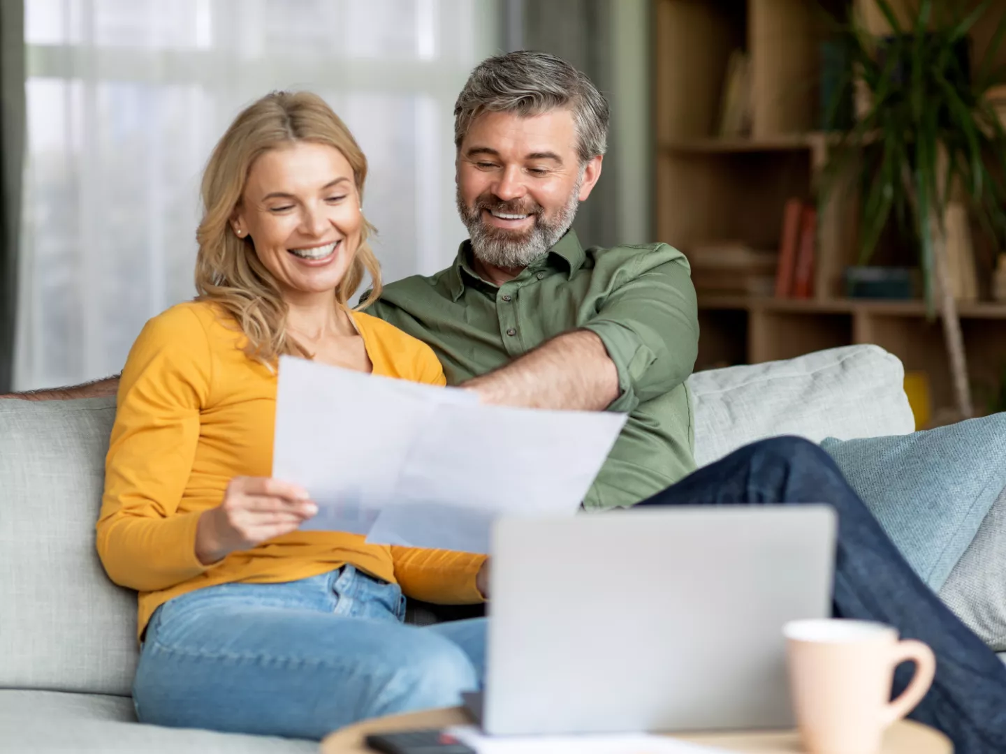 A couple going over paperwork smiling.